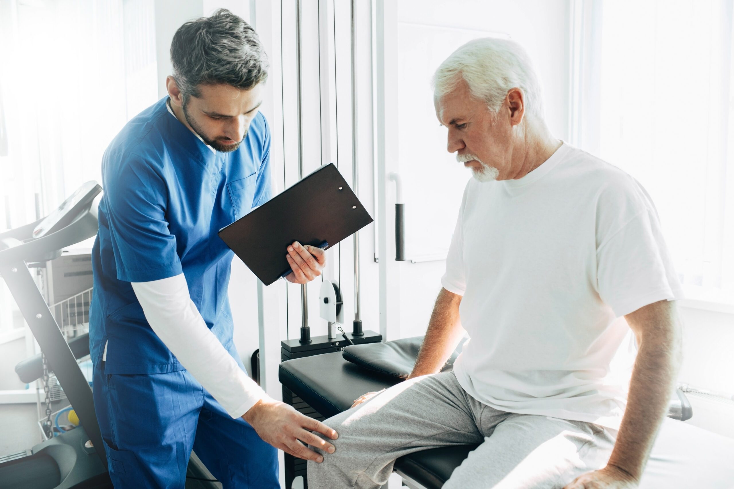 Doctor checking older man for physical